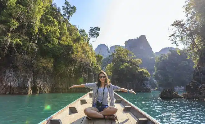 Photo of Woman Sitting on Boat Spreading Her Arms